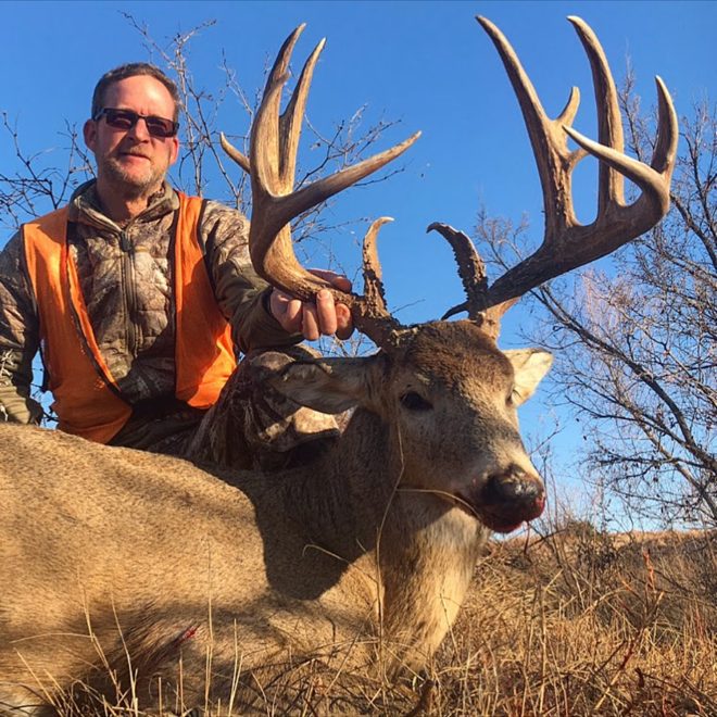 Hunter with a tall-tined northwest Oklahoma whitetail buck