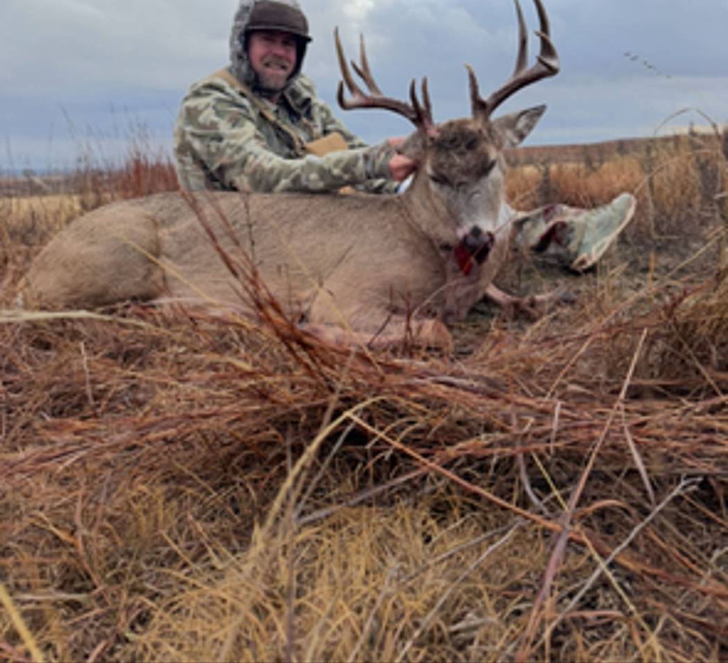 A hunter with a mature Oklahoma whitetail
