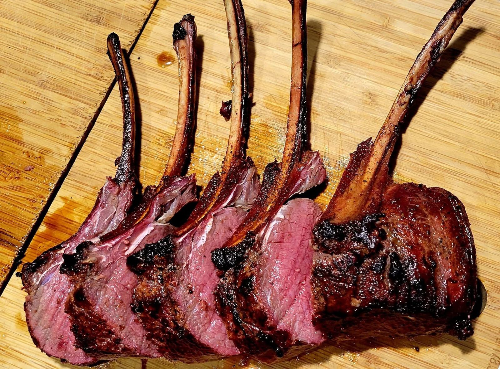 A frenched rack of chops sliced on the cutting board