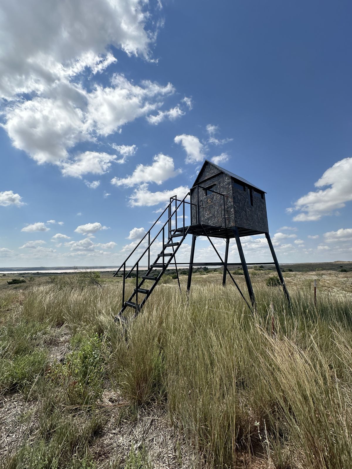 An elevated box blind on the edge of the river breaks