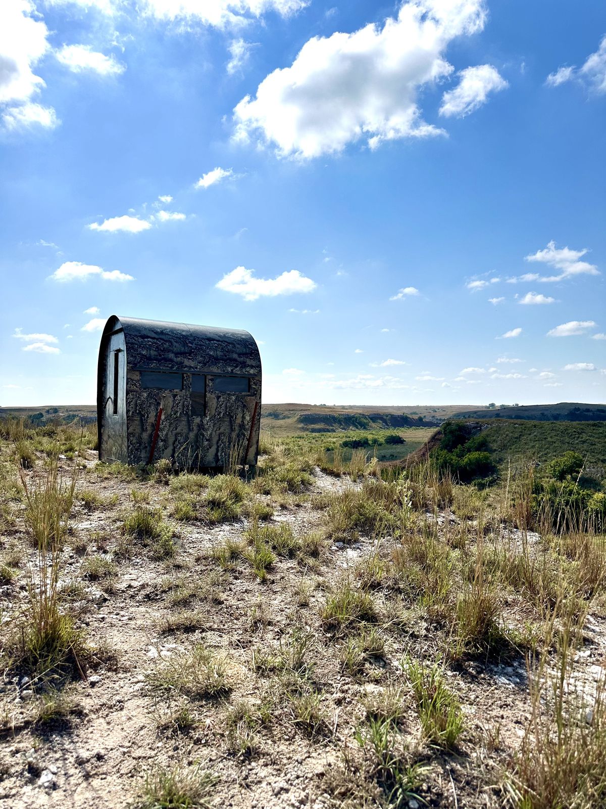 A ground blind on a prairie ridge above the draws
