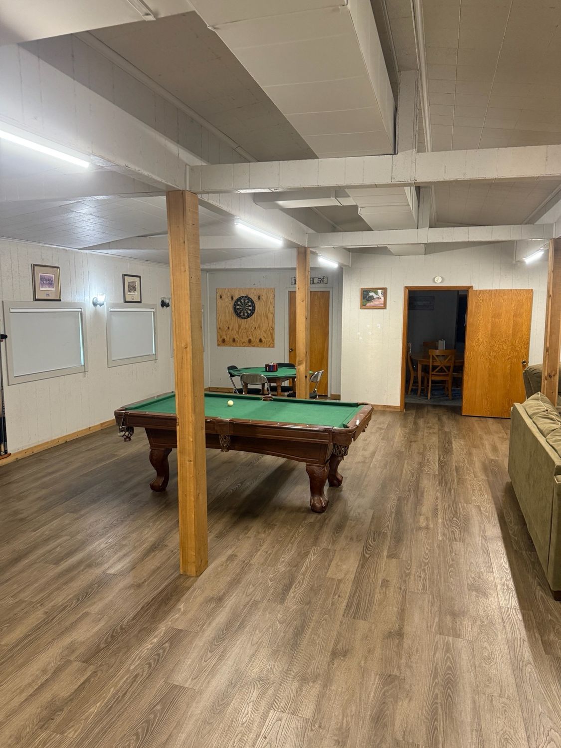 Pool table and dart board in one of the Canton Lake Lodge living areas