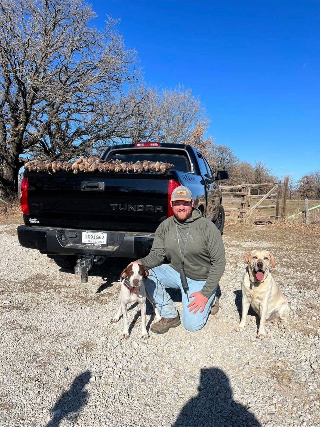 A hunter with the dogs and the day&rsquo;s birds
